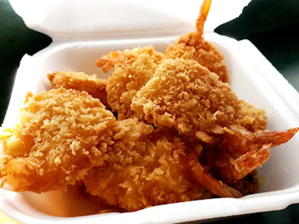 Crispy coconut fried shrimp served in a takeout box